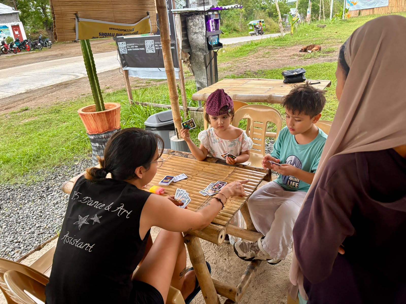 Children and family enjoying a card game together at B&Y Agri Tourism Park