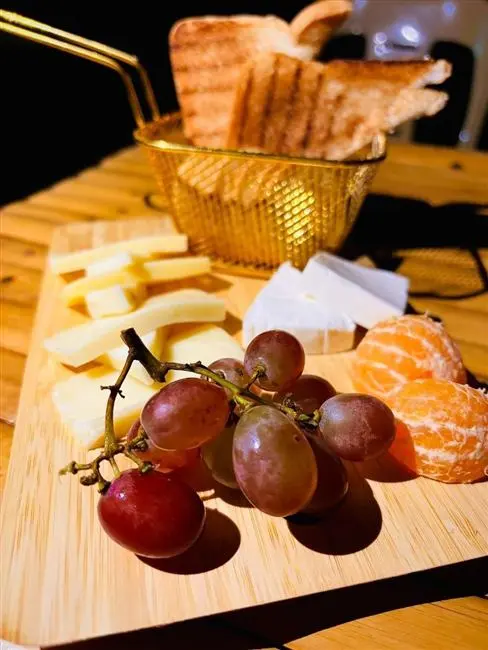 Cheese and fruit board with toasted bread