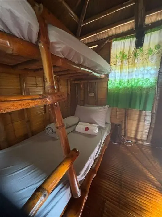 Inside a B&Y Agri Tourism Park Kubo hut, showing bamboo bunk beds