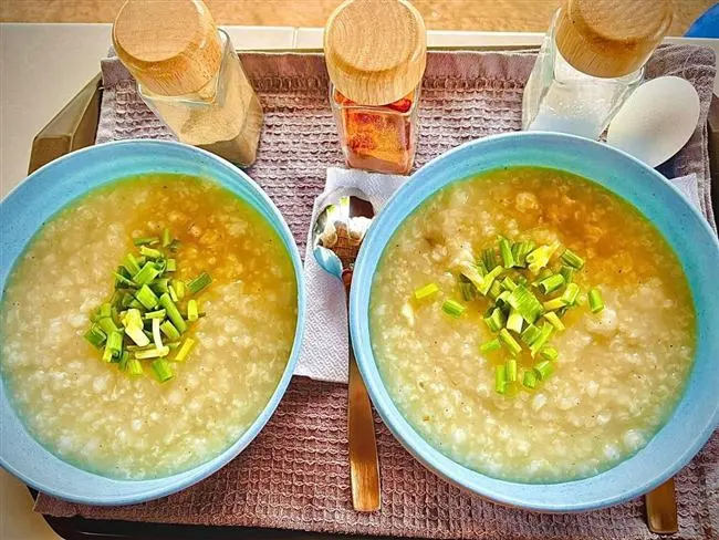 Two bowls of arroz caldo porridge