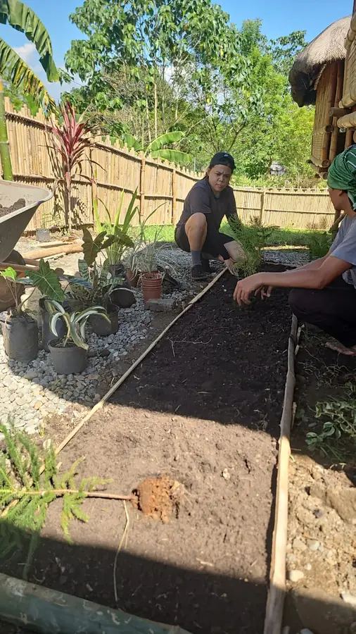 Volunteer helping prepare a garden bed at B&Y Agri Tourism Park